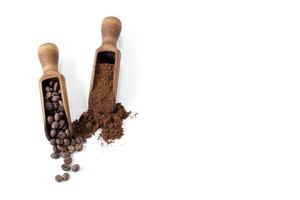 Wooden scoops with ground and whole bean coffee on a white background photo