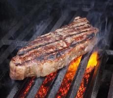 Grilled meat on open flame photo