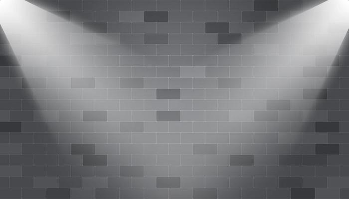 Corner spotlights illuminated on a brick wall