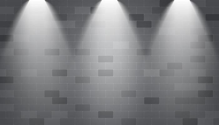 Spotlights illuminated on a brick wall