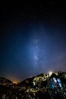 Milky Way over city lights photo