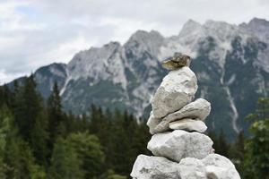 A stack of stones near a mountain photo