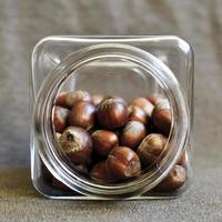 Hazelnuts in a clear jar photo