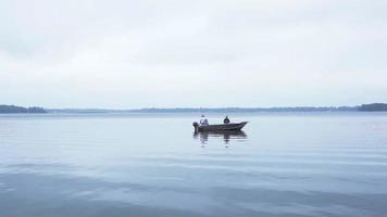 Man and woman fishing in boat.