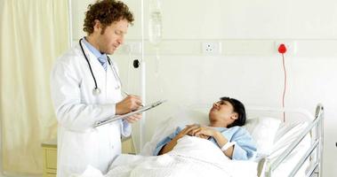 Doctor talking to sick patient in bed