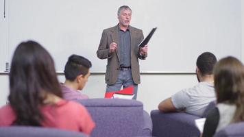 A professor speaks to his class video