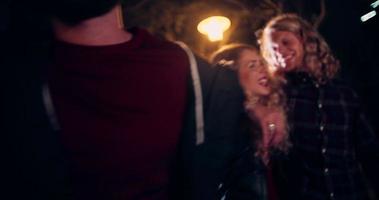 Teenager hipster friends hugging together in city at night video