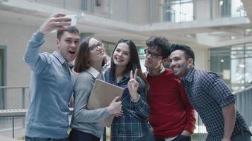 gruppo di giovani studenti multietnici utilizza un tablet in un'università. video