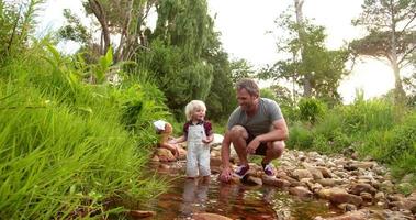 Adventurous child exploring the world and river with his dad video