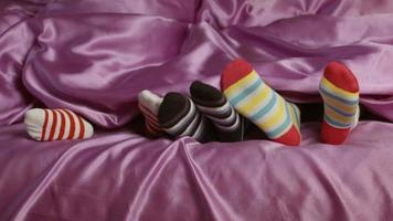Small feet in colorful socks.