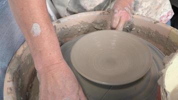 potter working with clay