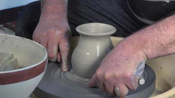 potter working with clay