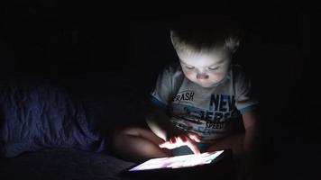 Little boy uses the tablet. 4K