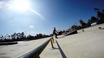 Skateboarder sliding down rail video