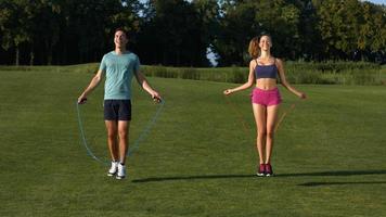 Guy and  girl are jumping on the jump rope. video