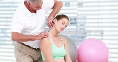 Pregnant woman getting a neck massage
