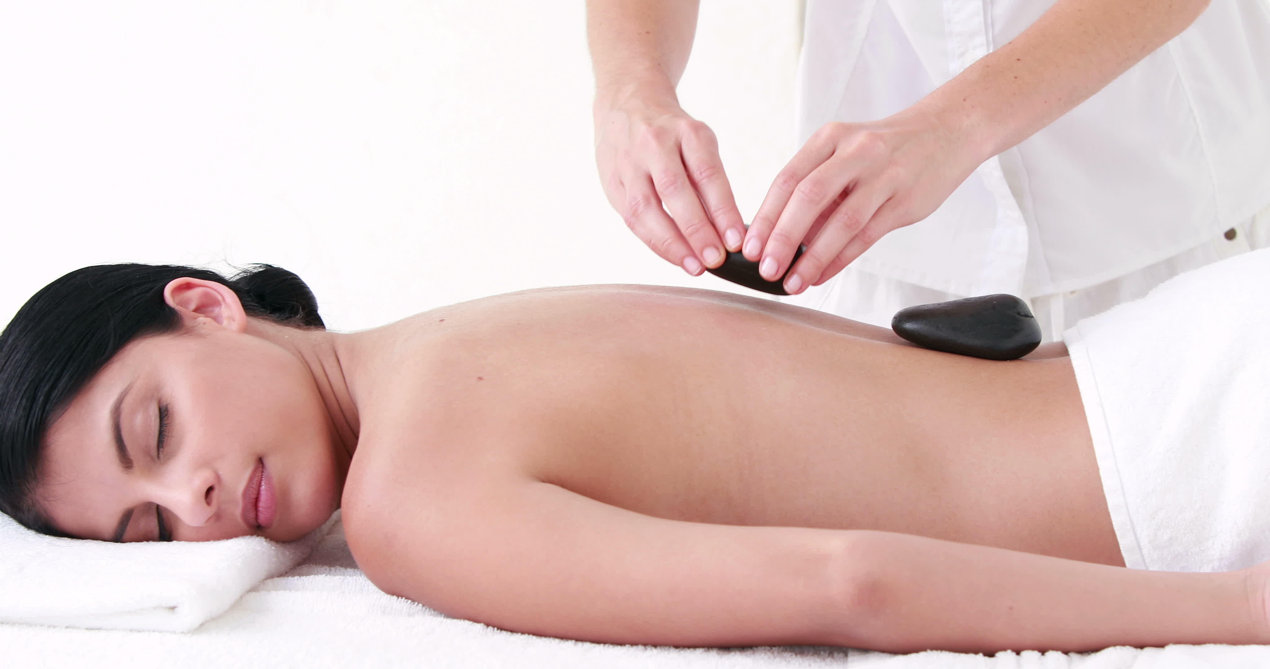 Woman enjoying a hot stone massage 1287837 Stock Video at Vecteezy