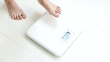 woman weighing on the scale video