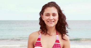 schöne lächelnde Brünette im Bikini am Strand video