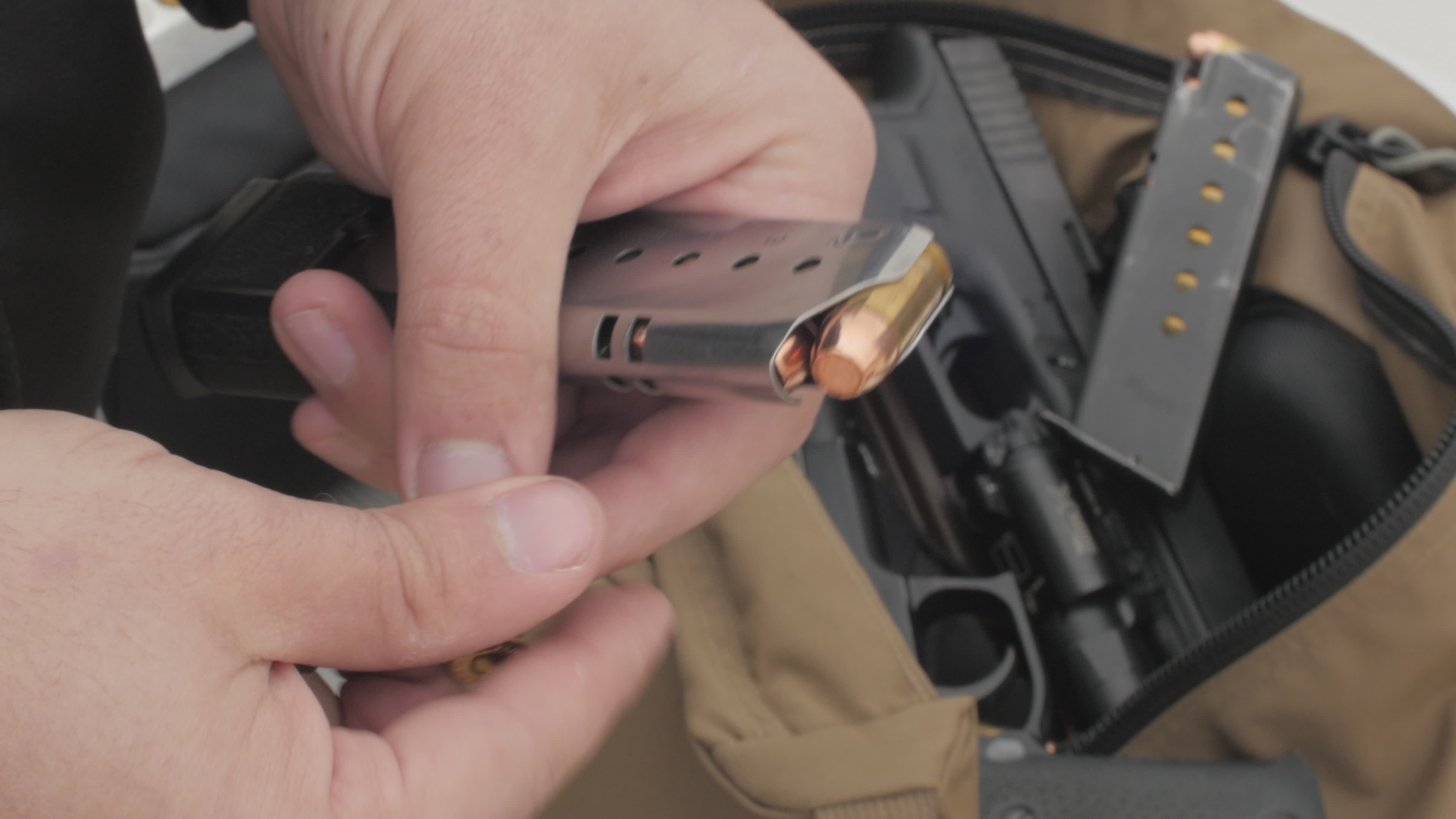 Man Loading Bullets Into a Pistol Magazine 1294432 Stock Video at Vecteezy