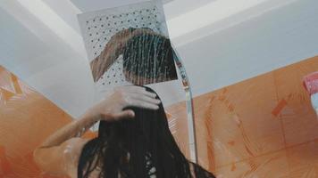 Brunette girl taking shower. Relax. Body care. Hygiene. Wash hair. Water video