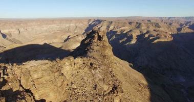 4K Male tourist standing on rock pinnacle overlooking the Fish River Canyon video