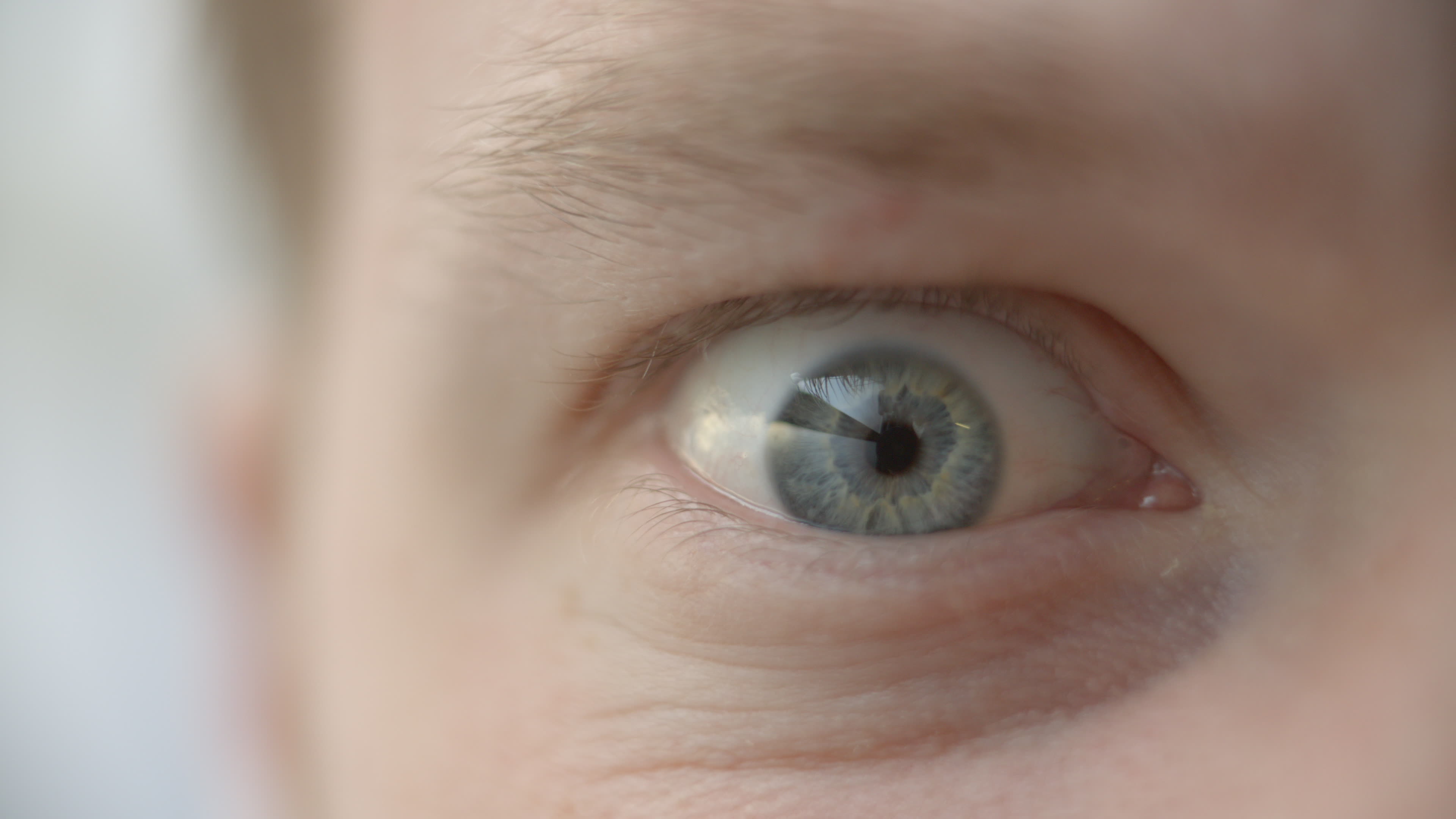 Extreme close up of a mans eye wide open in fear or anger 1296191 Stock