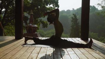 Man sitting on splits and yoga