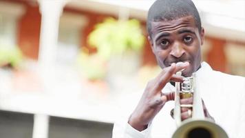 Black man plays a trumpet in the street video