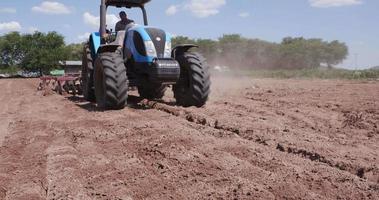 Tractor ploughing farm fields video