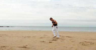 Fit man practicing martial arts video