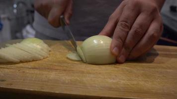 Man cutting onion in the kitchen video
