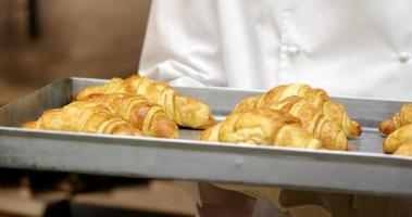 Chef showing tray of croissants