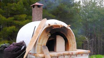 Brick, clay oven fire outdoor in forest garden video