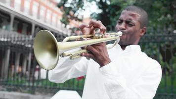 schwarzer Mann spielt eine Trompete auf der Straße