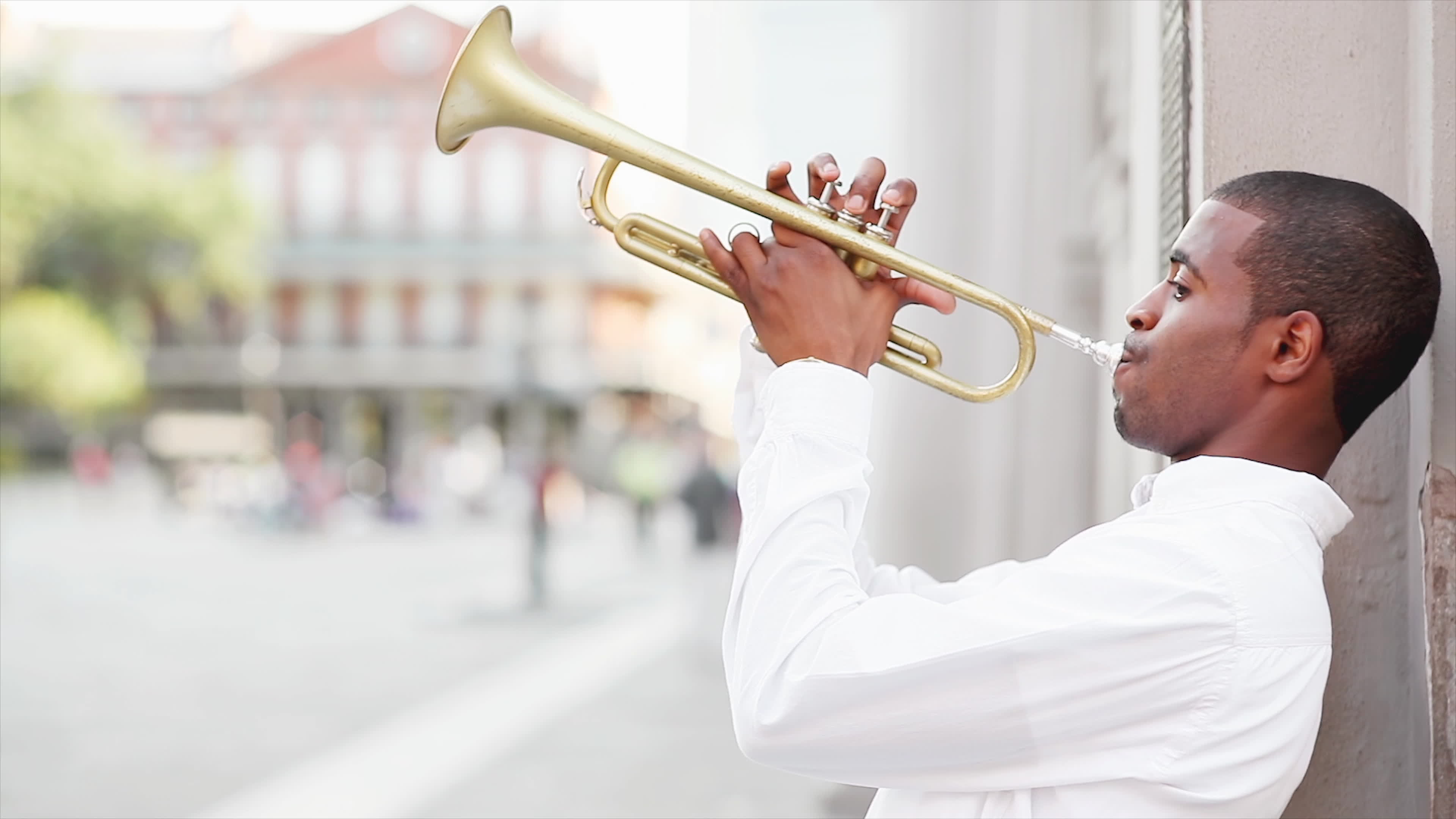Black man plays a trumpet in the street 1297335 Stock Video at Vecteezy
