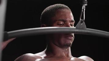 Muscular black man performing a lat pulldown video