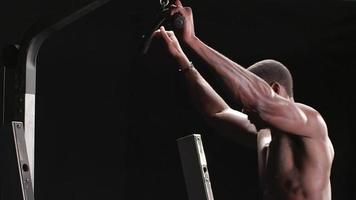 Muscular black man performing a lat pulldown video