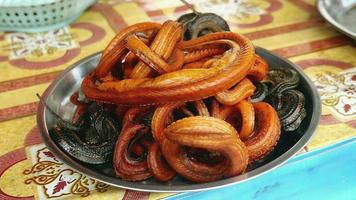 Various species of fried snakes for selling at street market