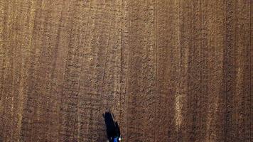 Aerial view of tractor sowing wheat
