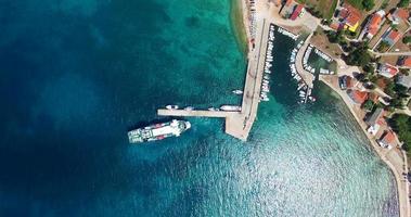 Flygfoto över färjan som lämnar hamnen på Olib Island
