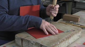 leather goods master craftsman at work video