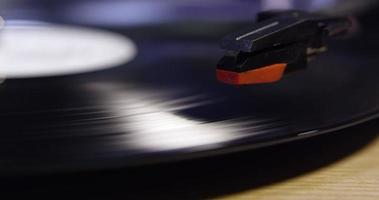 Stylus lowering on to vinyl record, and raising, close up, shot on R3D video
