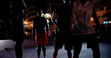 jogadores de basquete jogando na quadra durante a noite