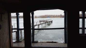 Frozen old pier at river side