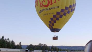 Hot air balloon slowing floats up video