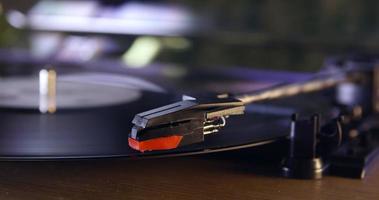 Turntable stylus lowering on to vinyl record, close up, shot on R3D video