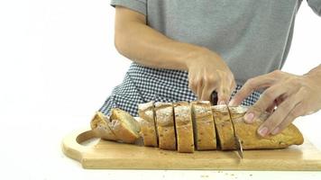Slicing baguette on chopping board