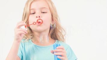 Little girl blowing soup bubbles video