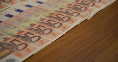 Dinero en efectivo de cincuenta euros sobre la mesa de madera